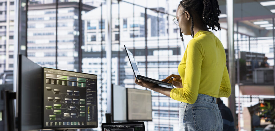 Engineer using laptop device, working with machine learning tech advancing AI critical to innovation of autonomous systems. Woman transforming data into predictive models using notebook