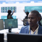 Business analyst looking into statistics and reports to detect any obstacles within the project structure, preparing solutions to ensure productivity. Manager studies firm numbers.